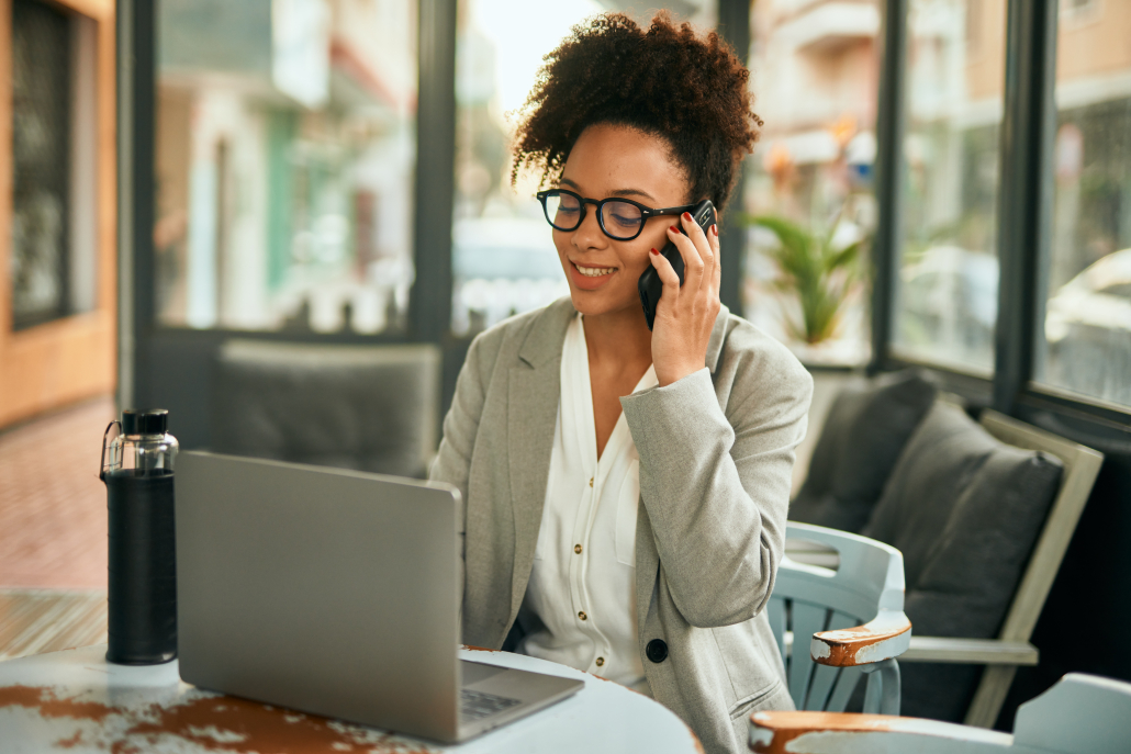 Young african american businesswoman working using smartphone talking on the smartphone.