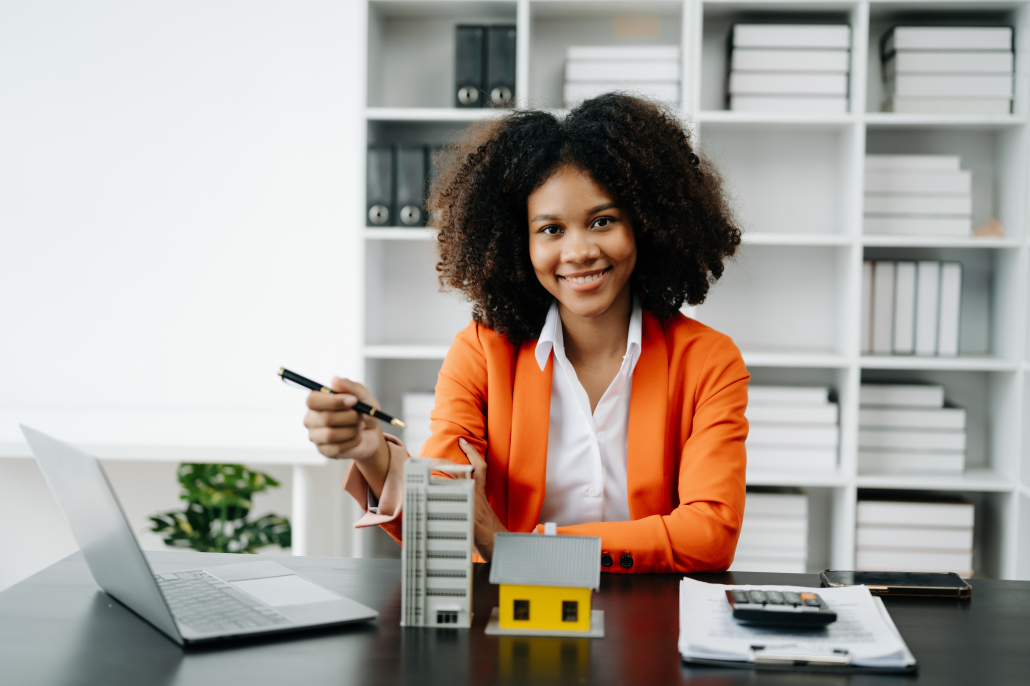 Young real estate agent worker working with laptop and tablet at